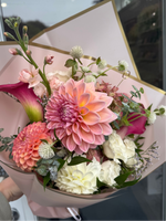 Bouquet of flowers held by a person with a blurred background